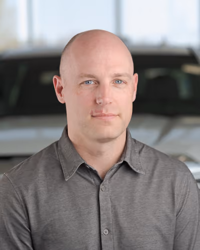 Ryan Thompson, General Manager, in front of dealership vehicles