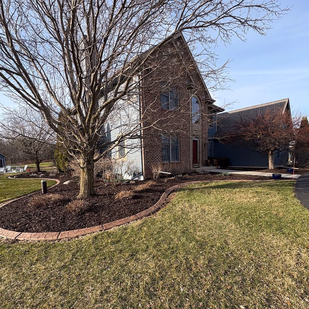 New landscape bed with decorative rock plants and grass in Southeastern Wisconsin