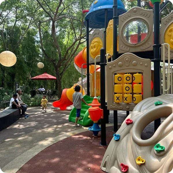 Children playing on a colorful playground with slides and climbing features