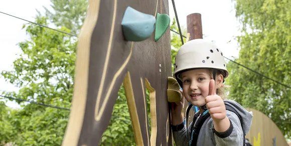 Girls exercising together on outdoor playground equipment