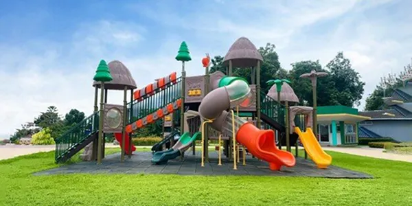 Multi-level playground with tube slides, climbing walls and themed rooftop towers