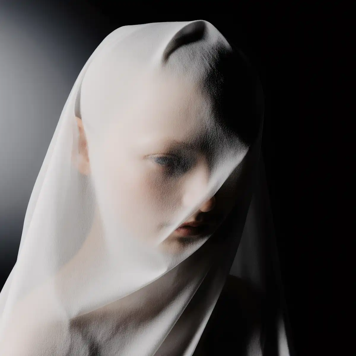 Woman captured in an ethereal portrait with soft atmospheric lighting.