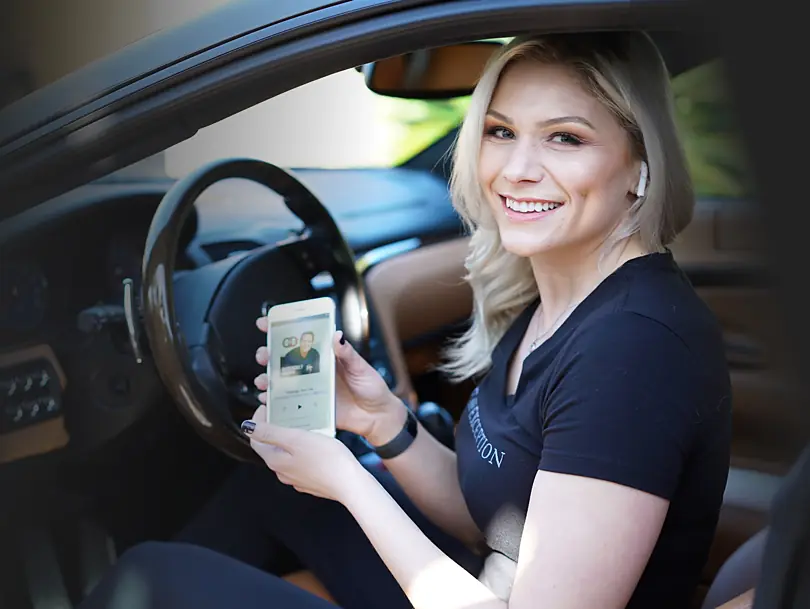 A DarrenDaily listener playing an episode on her phone before driving
