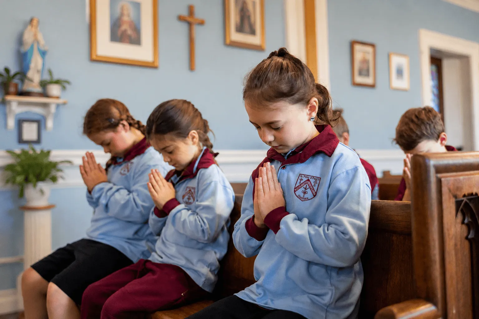 Primary school students praying in a church