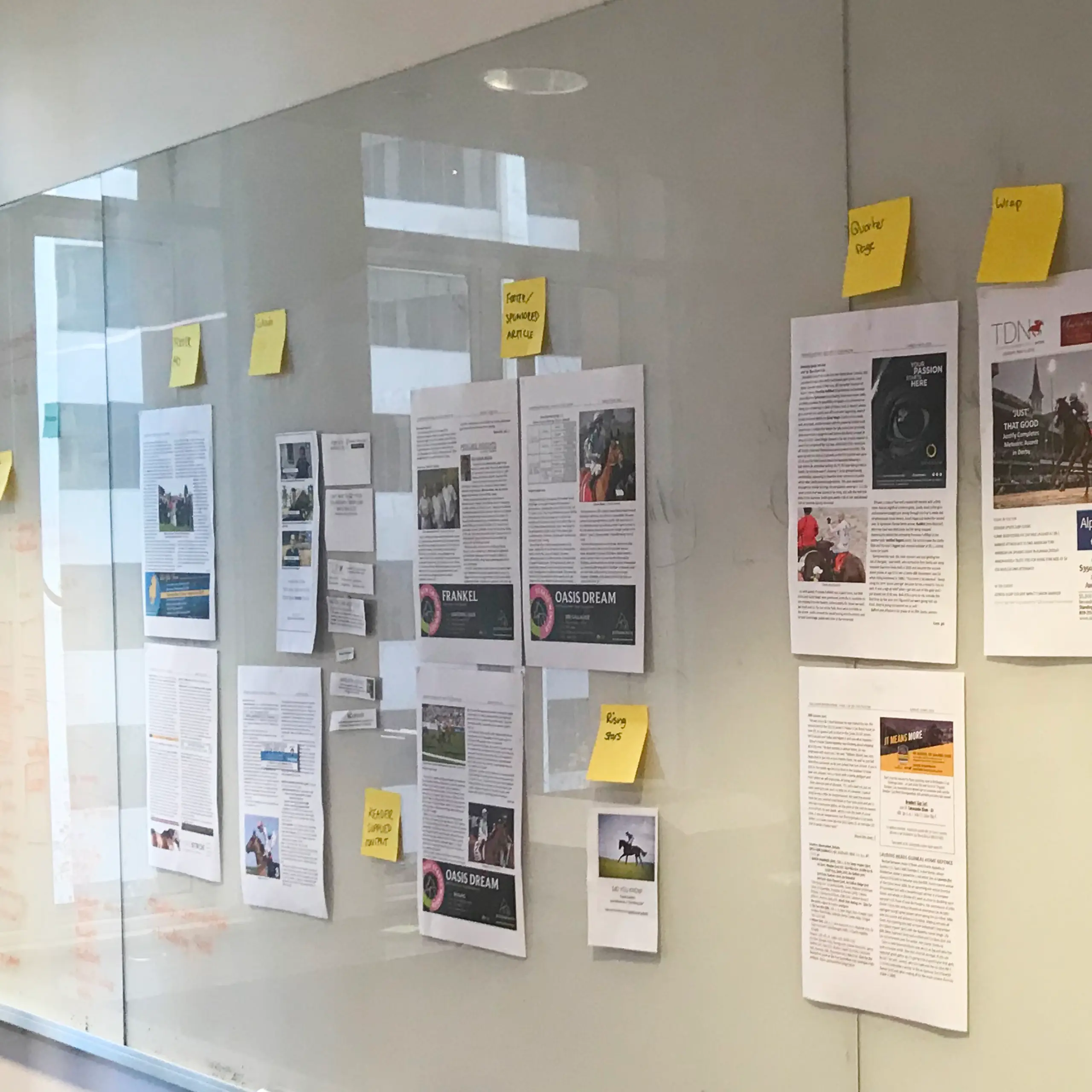 A photo from the workshop using post-it notes around printed pages of the website for feedback