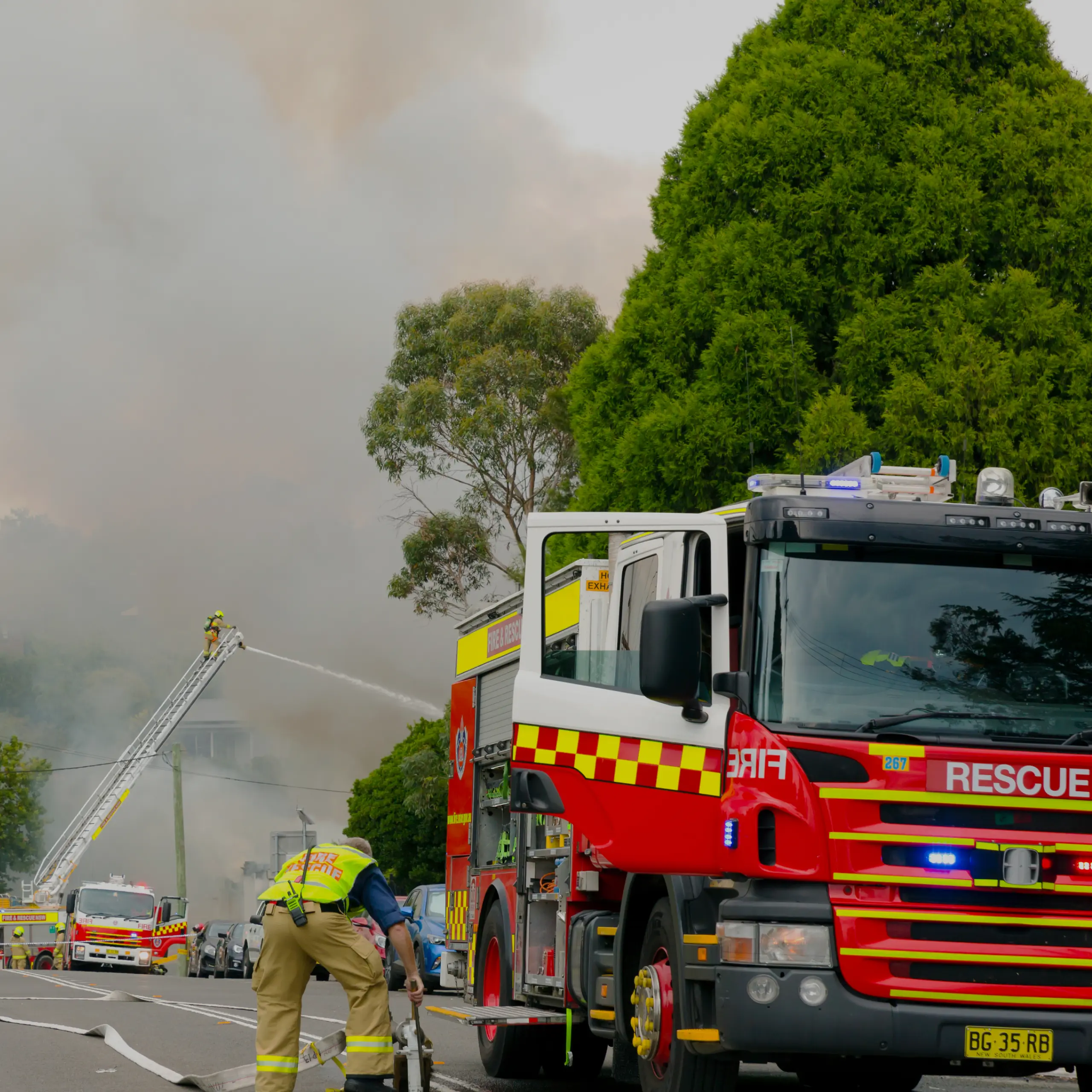 A fire truck and firefighters fighting a fire