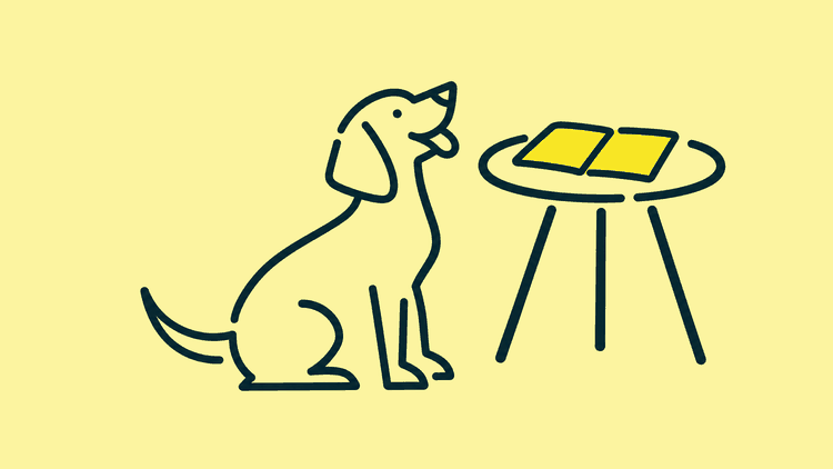 A dog sits beside a small side table with an open diary lying on it.