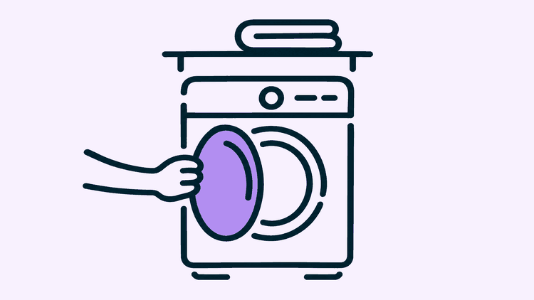 A hand pulls open the round door of a washing machine in a utility room to look inside.