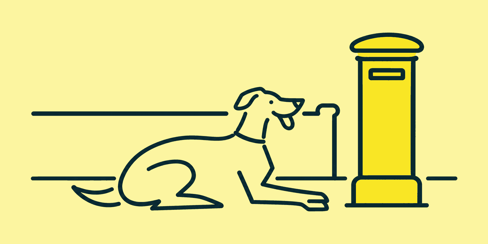 A lone dog lies alert on a quiet pavement beside a tall pillar box, with no owner in sight.