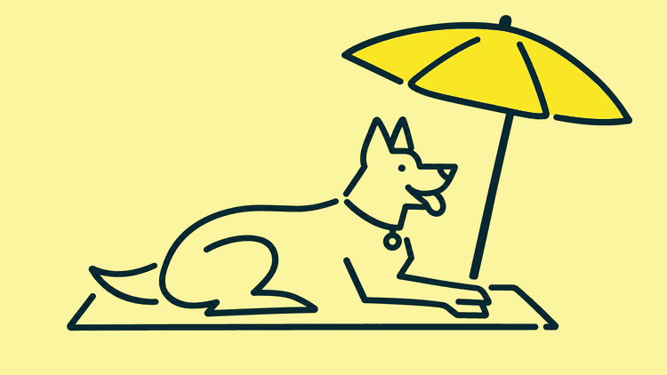 A German shepherd lies on a beach towel under a parasol.