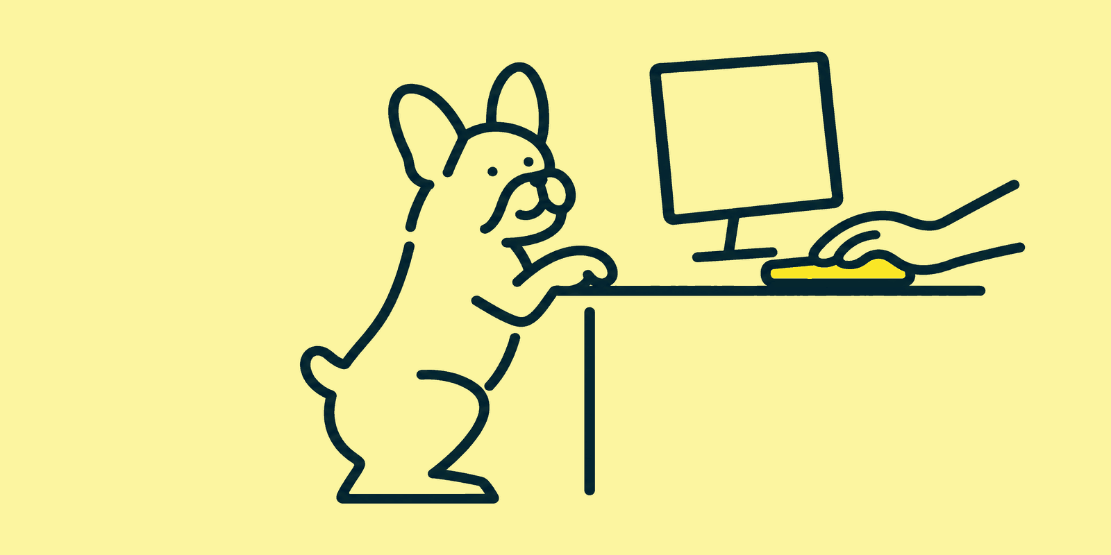 A French bulldog sits up on its back legs with its front paws on the edge of a desk, watching a hand type on a keyboard beside a blank monitor.