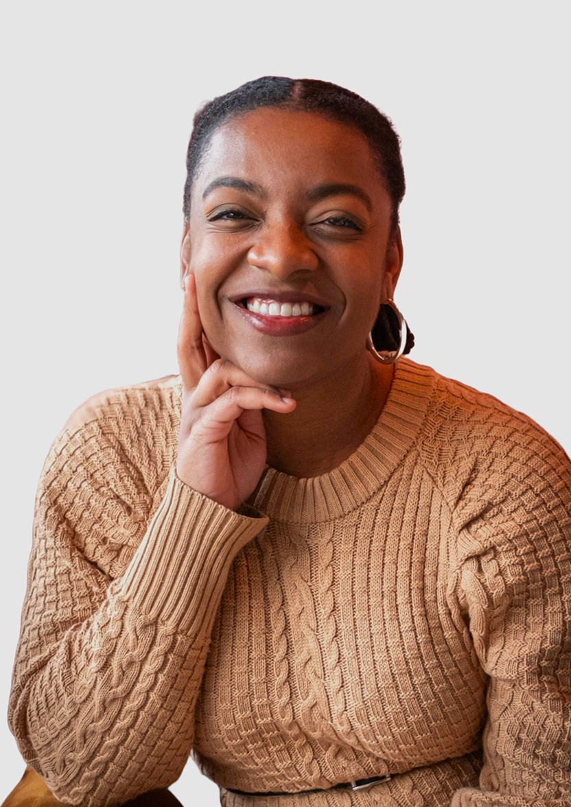 Professional headshot of Camille, a Chrysallis Lab client, smiling in a tan sweater