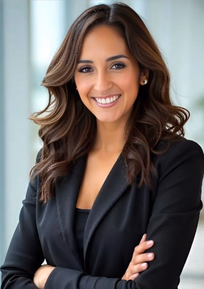 Professional headshot of Claudia Garcia, a Chrysallis Lab client, smiling in a black blazer with arms crossed