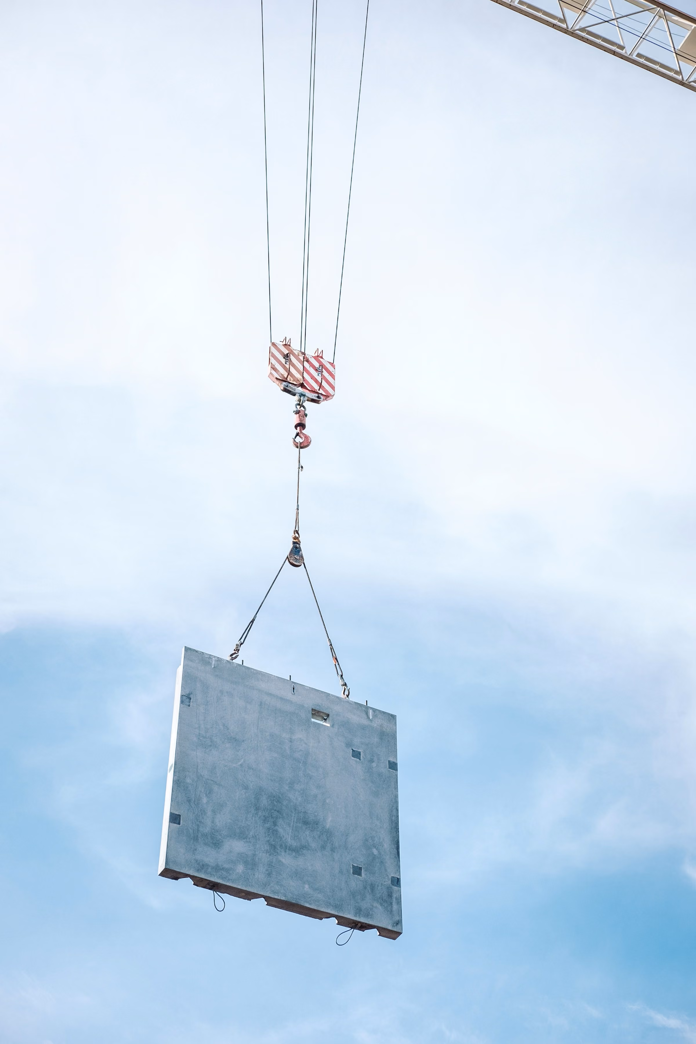 Slab of concrete being lifted by crane