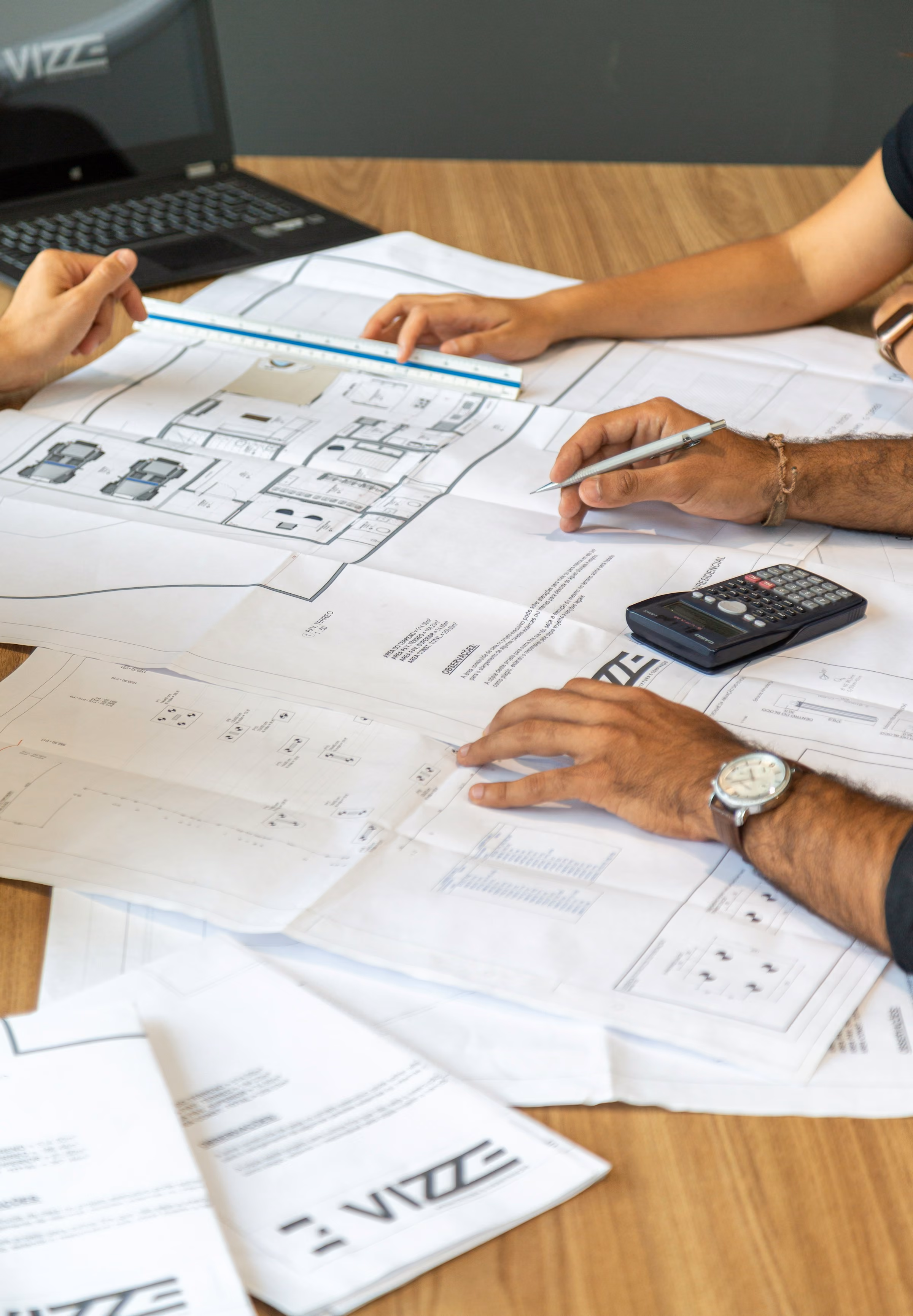 Discussing printed out designs and drawings