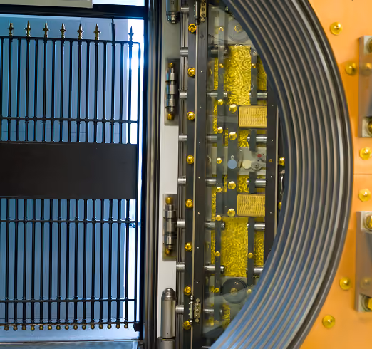 Open bank vault door showing intricate locking mechanisms and metal gate inside.