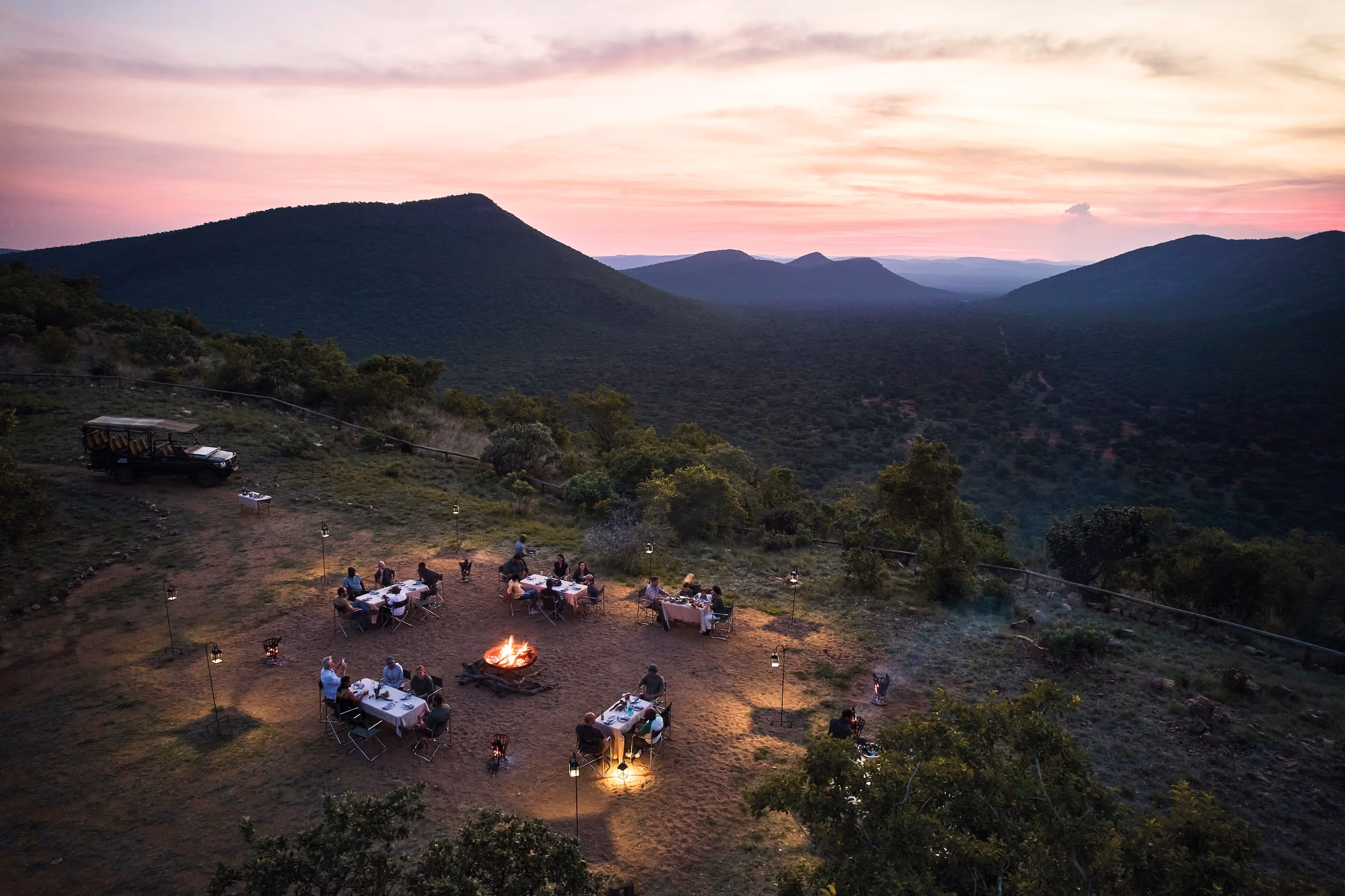 Guests at a boma dinner at sunset in the Waterberg