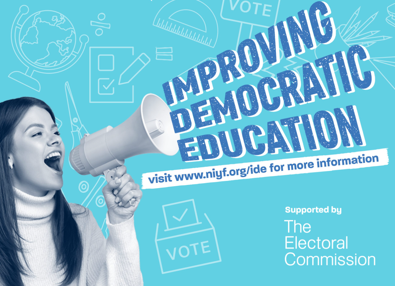 A woman with a loudspeaker blurring out the words 'Improving Democratic Education'