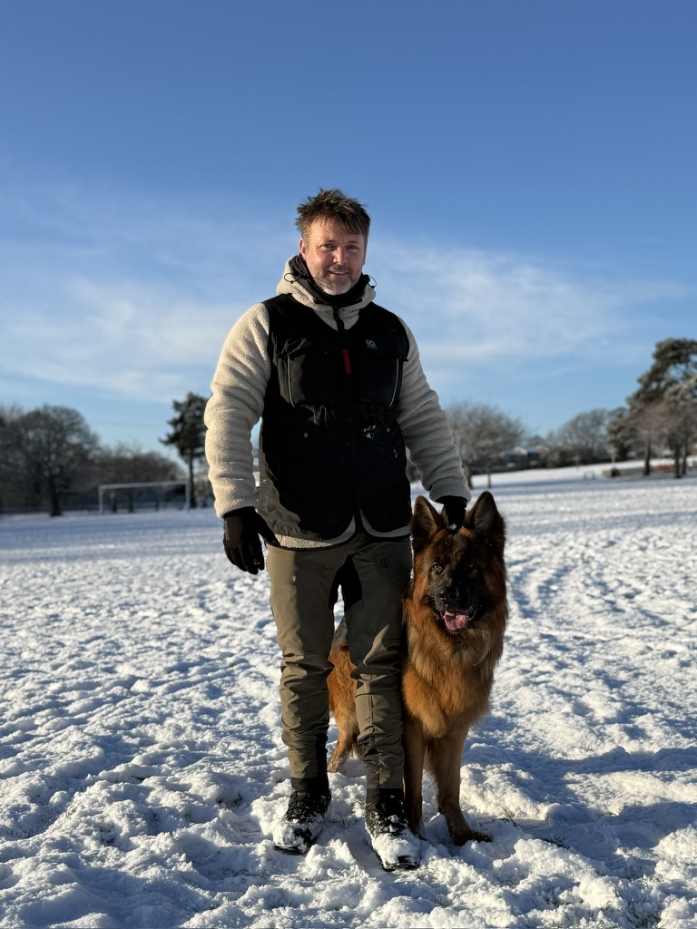 Scott McKay working with German Shepherd Puro at heel, off lead