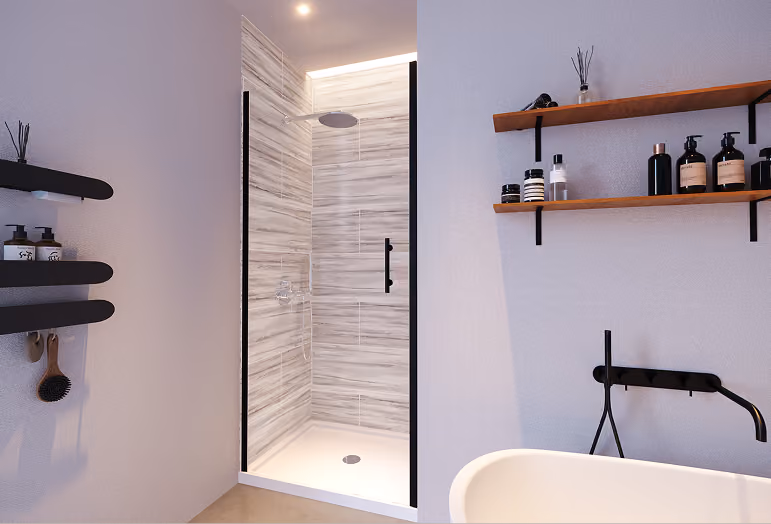 Modern bathroom with glass walk-in shower, black fixtures, wooden shelves, and various toiletry bottles.