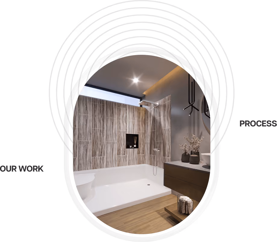 Modern bathroom with wood-textured tiles, walk-in shower, dark vanity, and decorative plants.