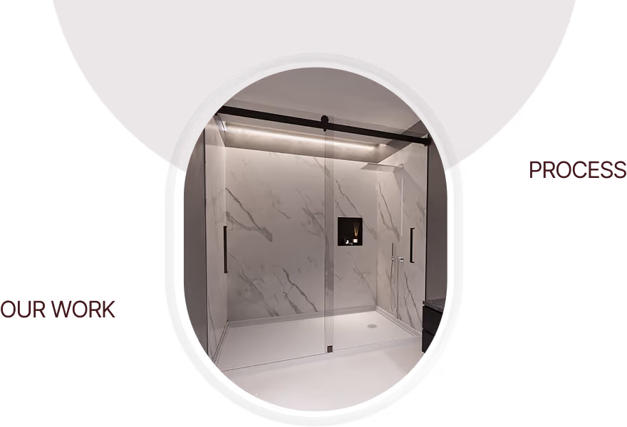 Modern walk-in shower with marble-pattern walls and glass sliding doors.