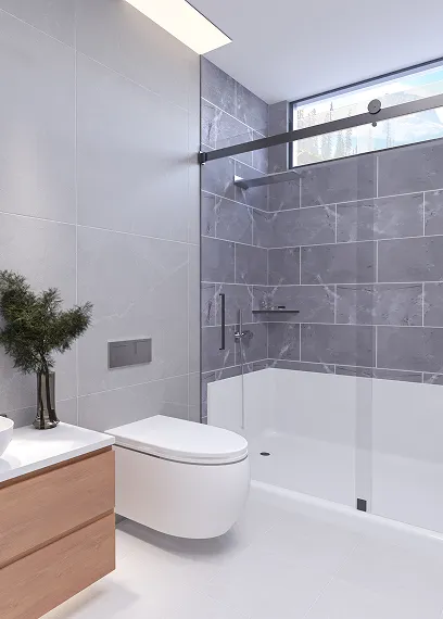 Modern bathroom with wall-mounted toilet, glass-enclosed shower, gray tiles, and wooden vanity with plant.