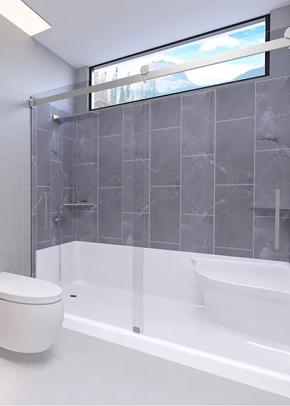 Modern bathroom with white bathtub, gray tiled wall, glass shower door, and a window showing mountains.