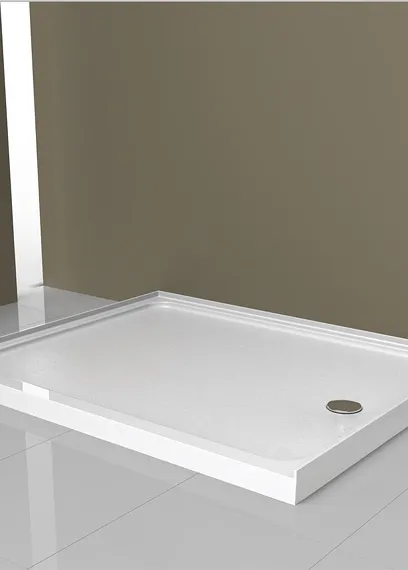 White rectangular shower tray installed on a tiled floor against an olive wall with a metal drain.