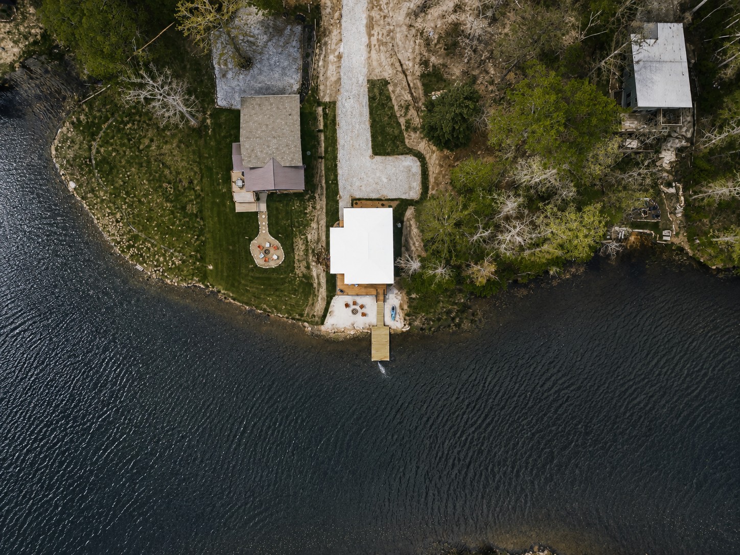 Aerial view of a Retreat at Water's Edge cabin with a private dock along the shoreline.