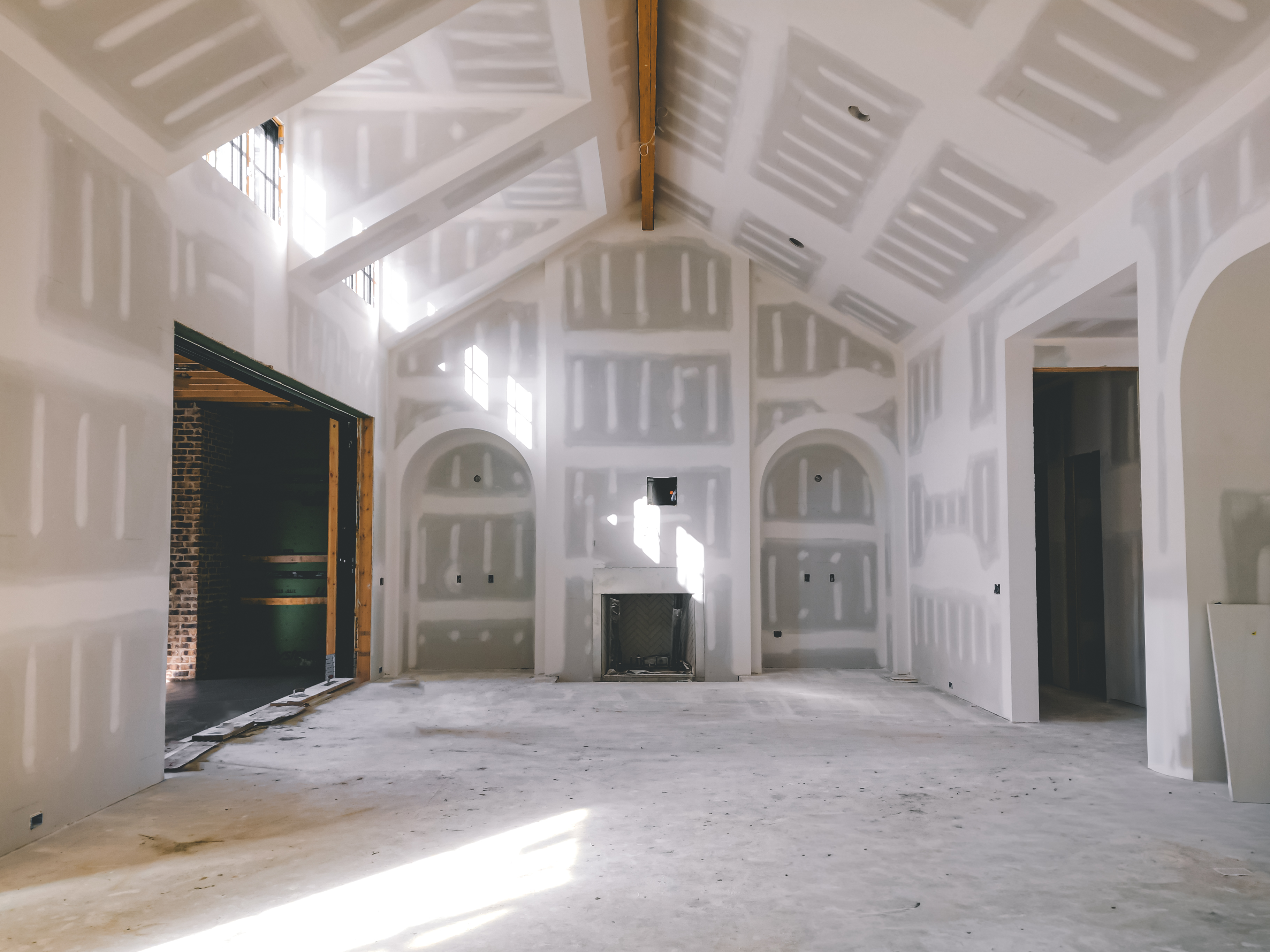 Vaulted interior of a Zurich Homes build under construction at 7001 Congress Drive, drywall finished with arched doorways.