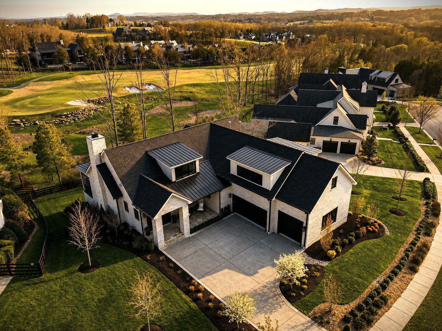 Aerial view of a Cornerstone Construction home bordering a golf course fairway.
