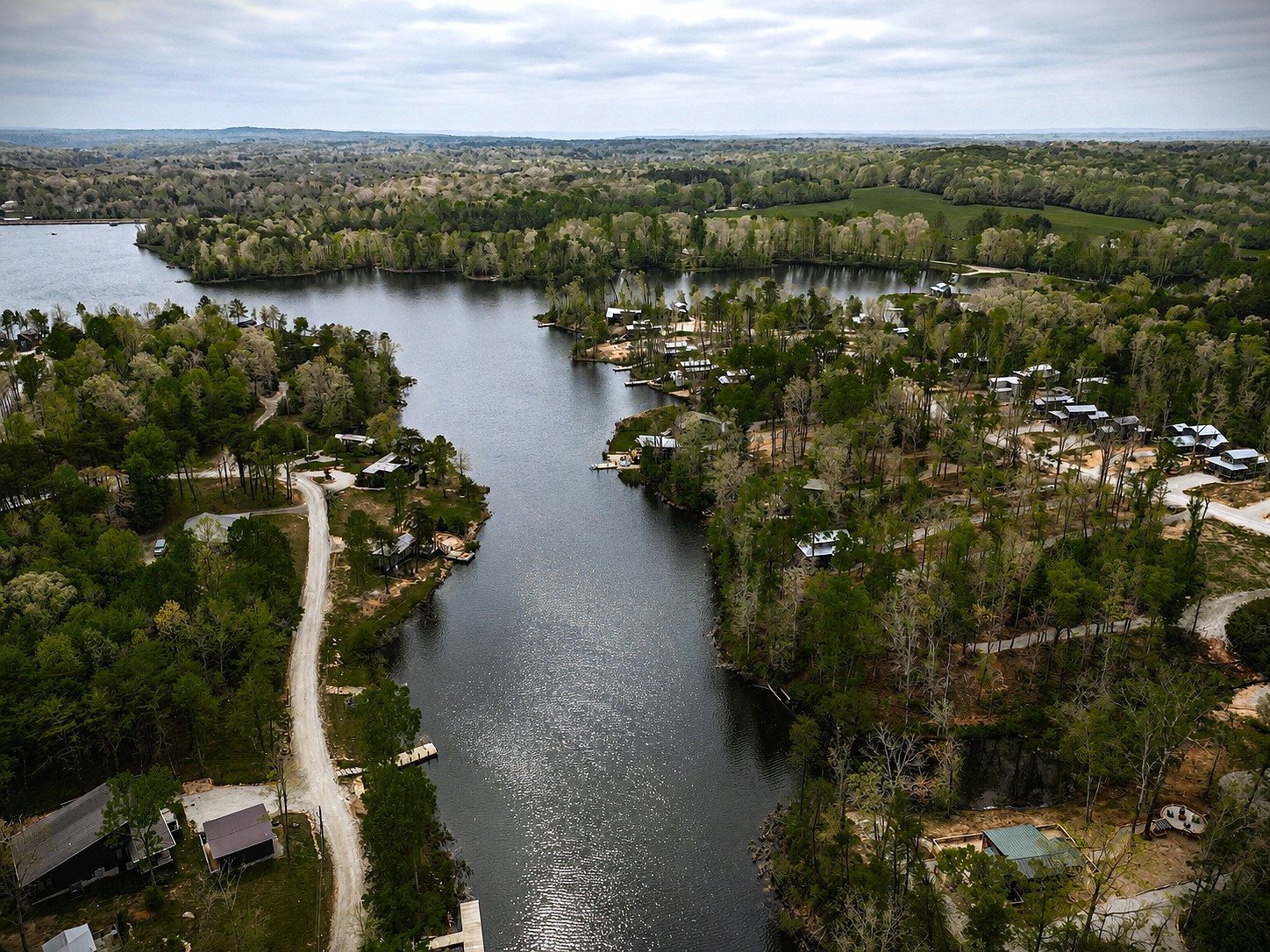 Aerial view of the wooded lake cove surrounding the Retreat at Water's Edge community.