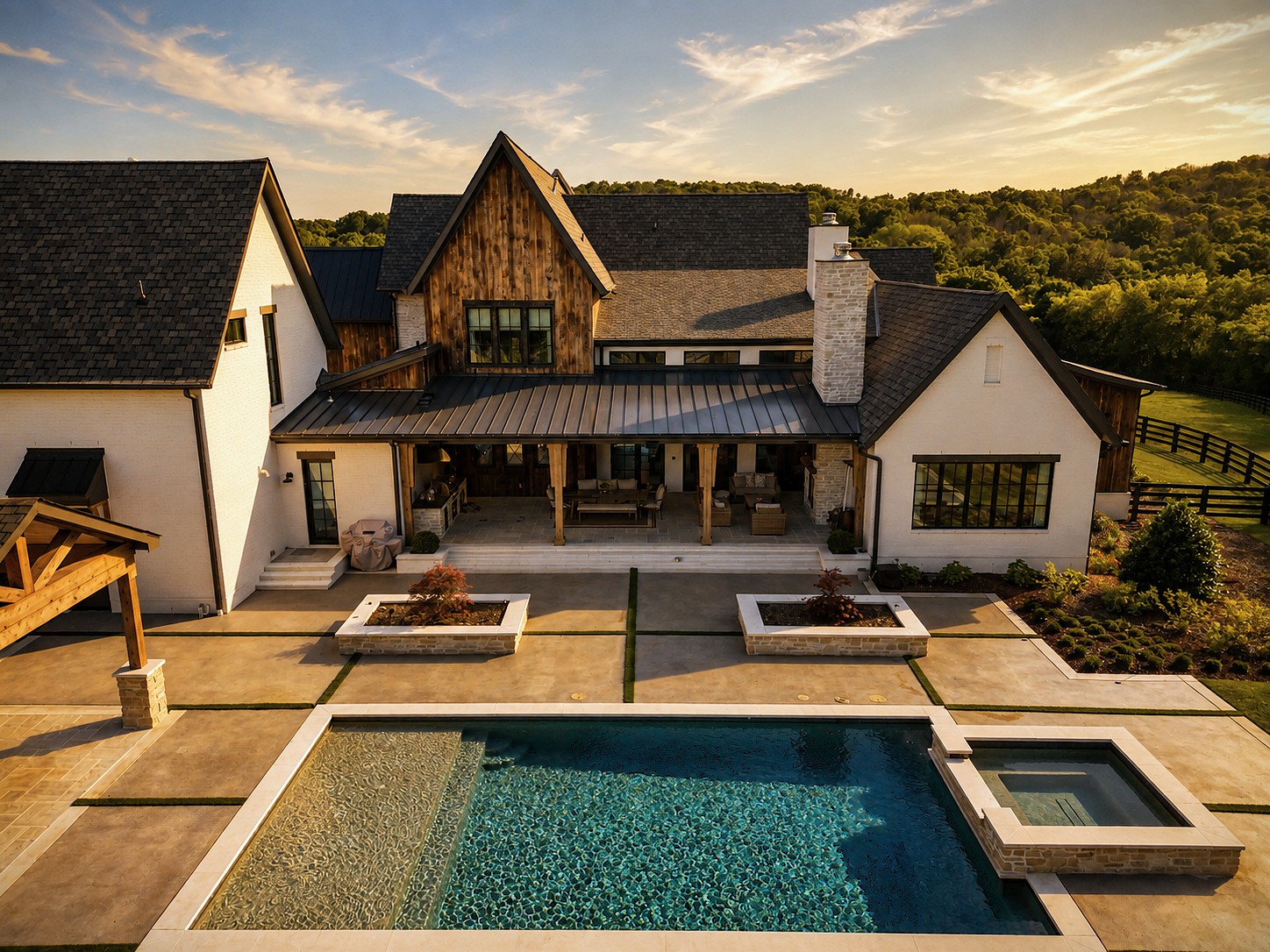 Rear view of a Cornerstone Construction home with a covered patio and pool at sunset.