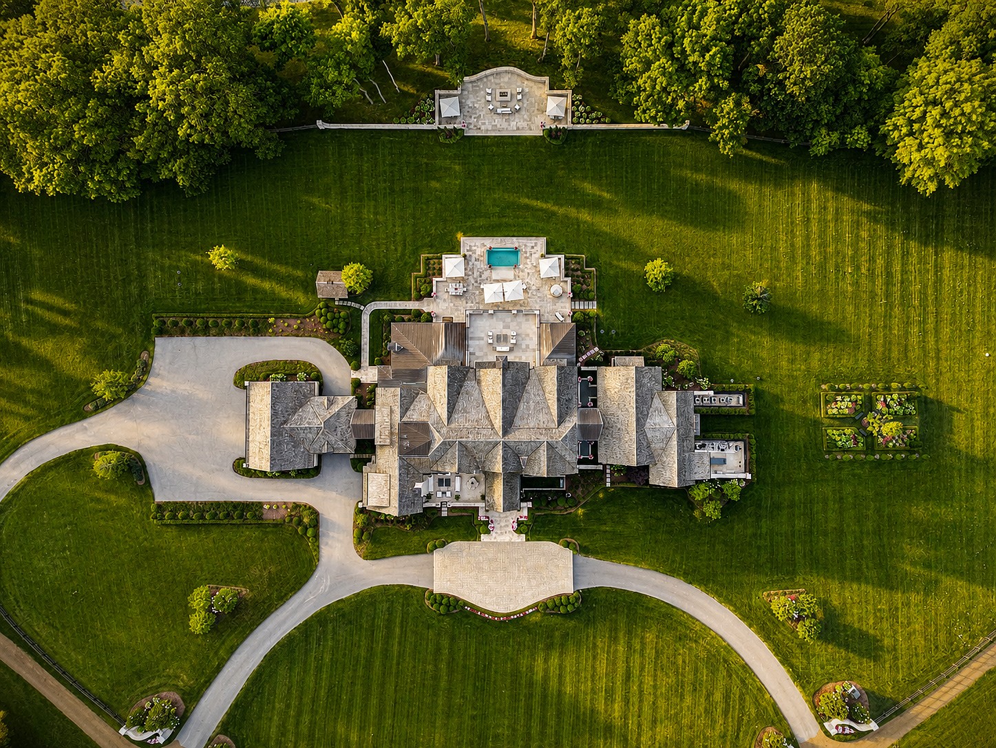 Top-down aerial view of a Castle Homes estate with a pool and manicured grounds.