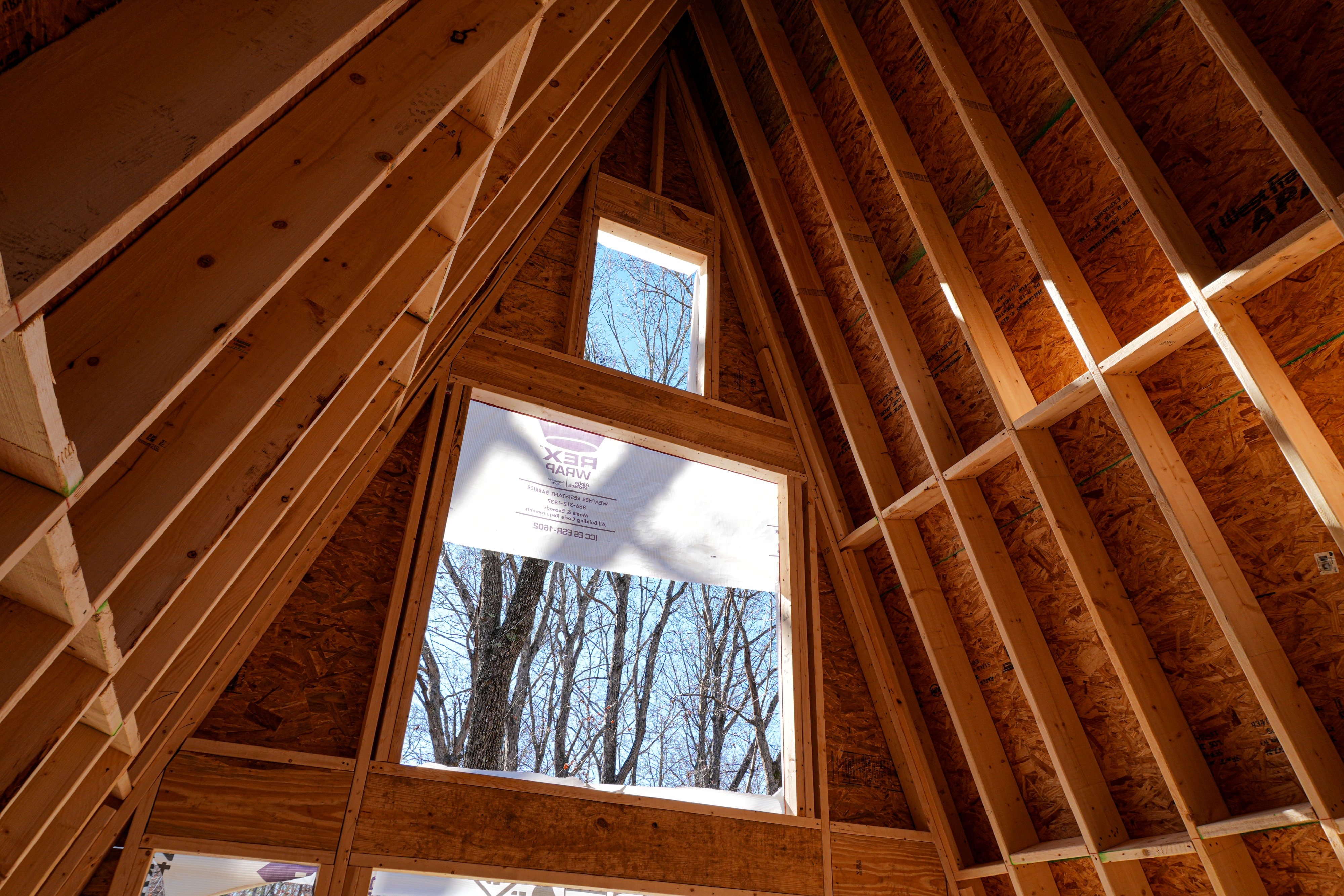 A-frame roof framing inside a Retreat at Water's Edge cabin under construction.
