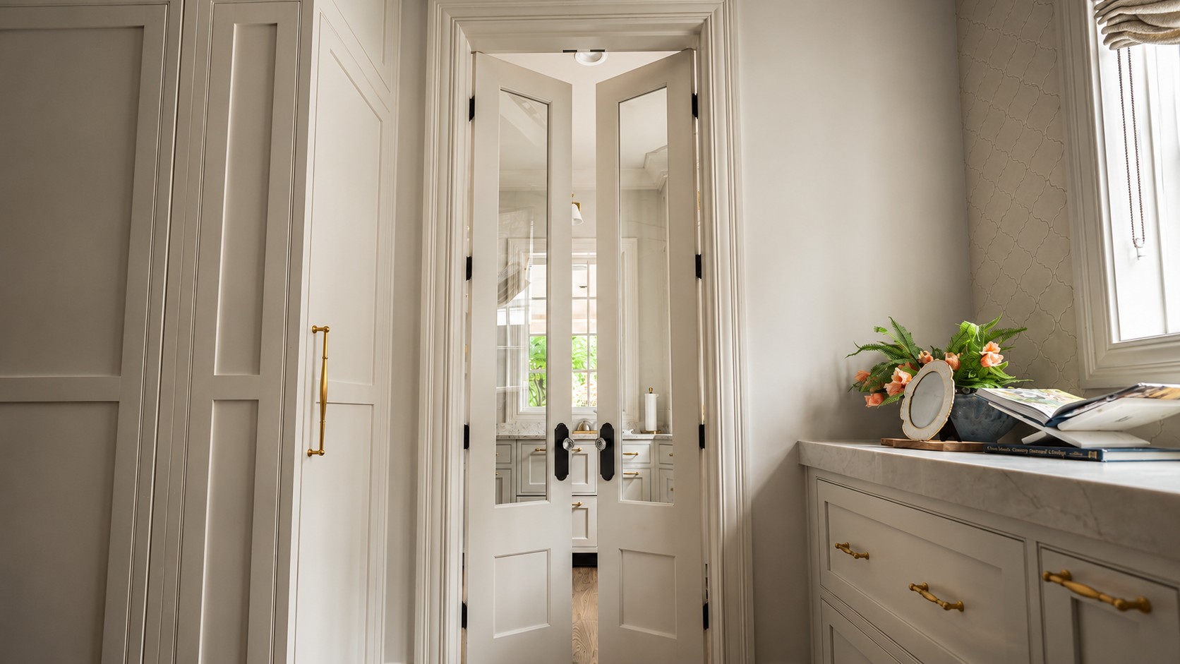 Hallway at Magnolia Hall with mirrored doors and a marble-top console.