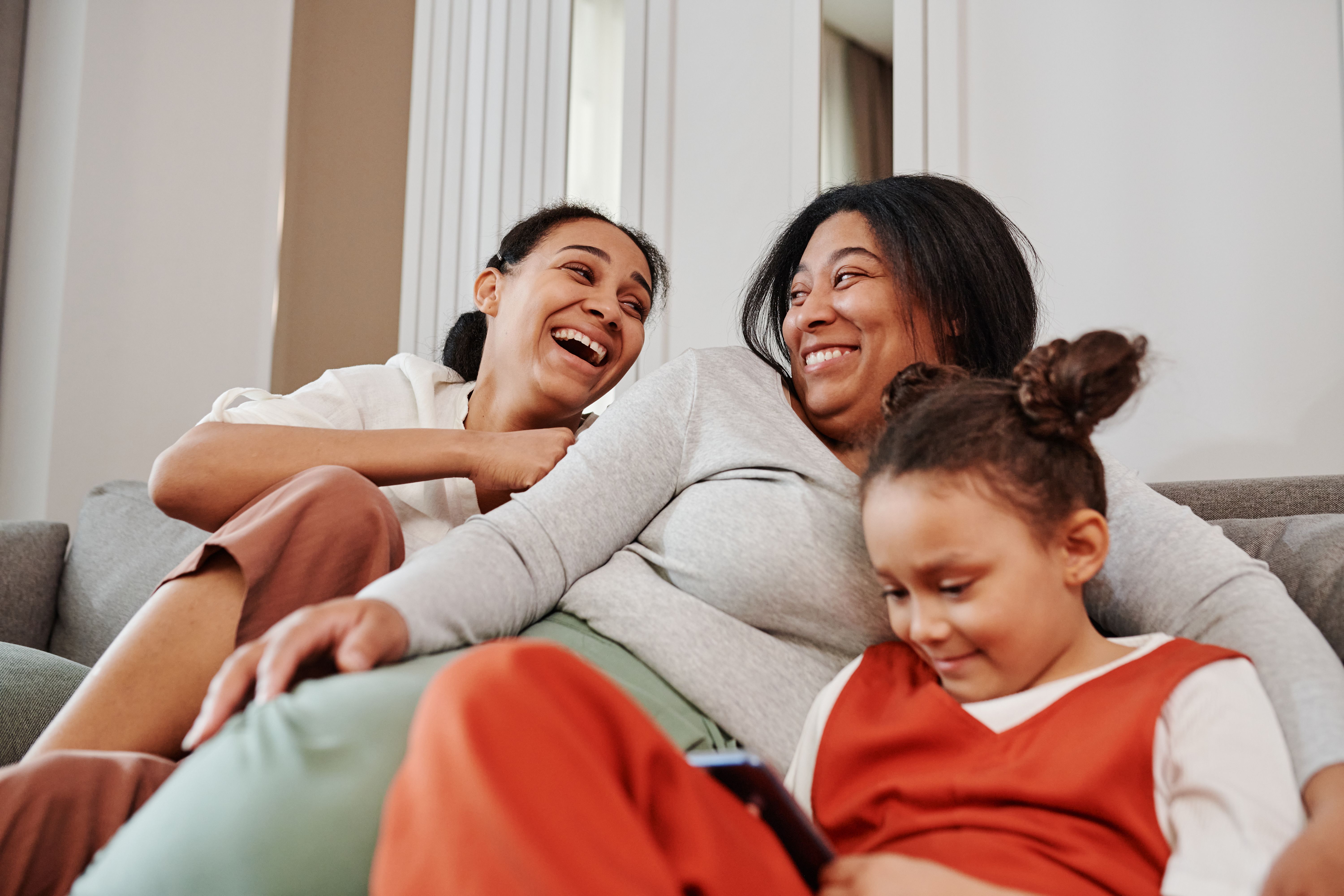 Family on couch playing stock image