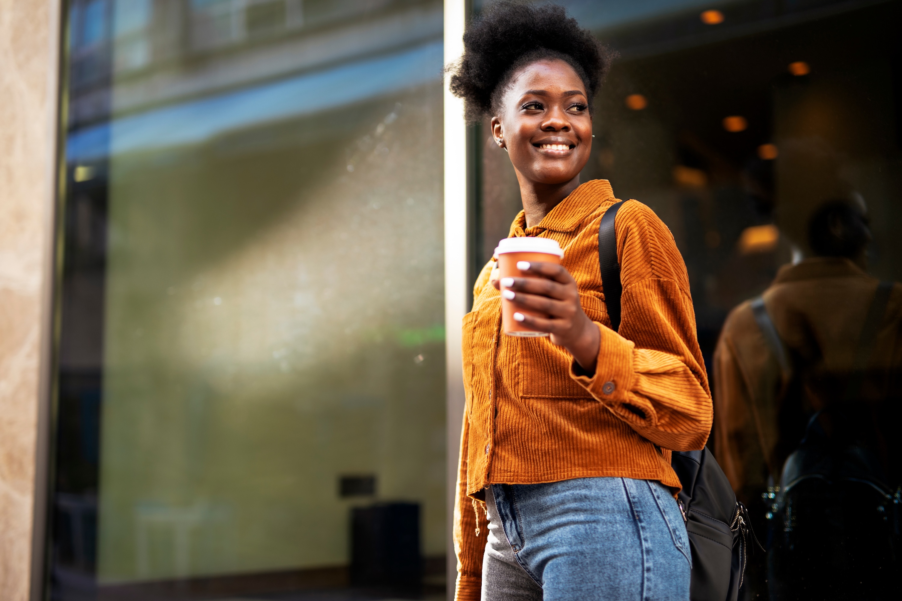 Person walking with coffee stock image