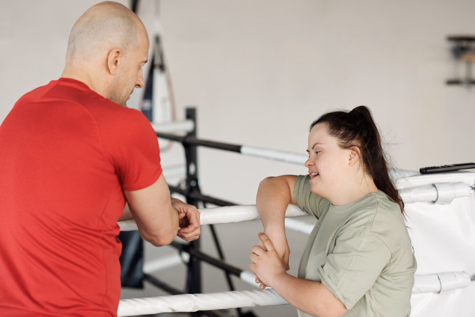 A coach talking with a participant at the gym