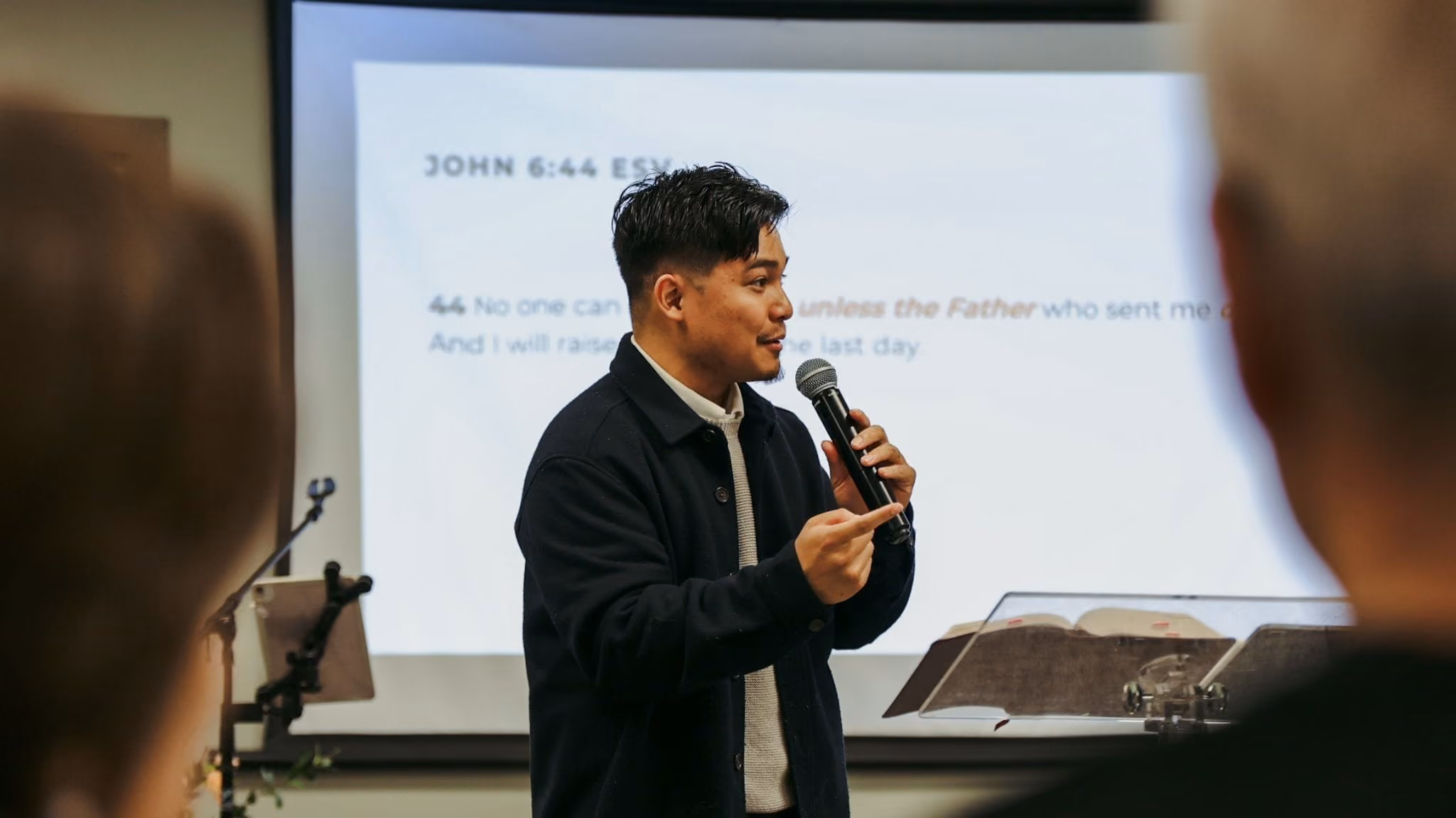 A medium shot of a pastor preaching.