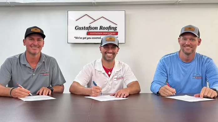 The Gustafson Roofing team standing together at a job site