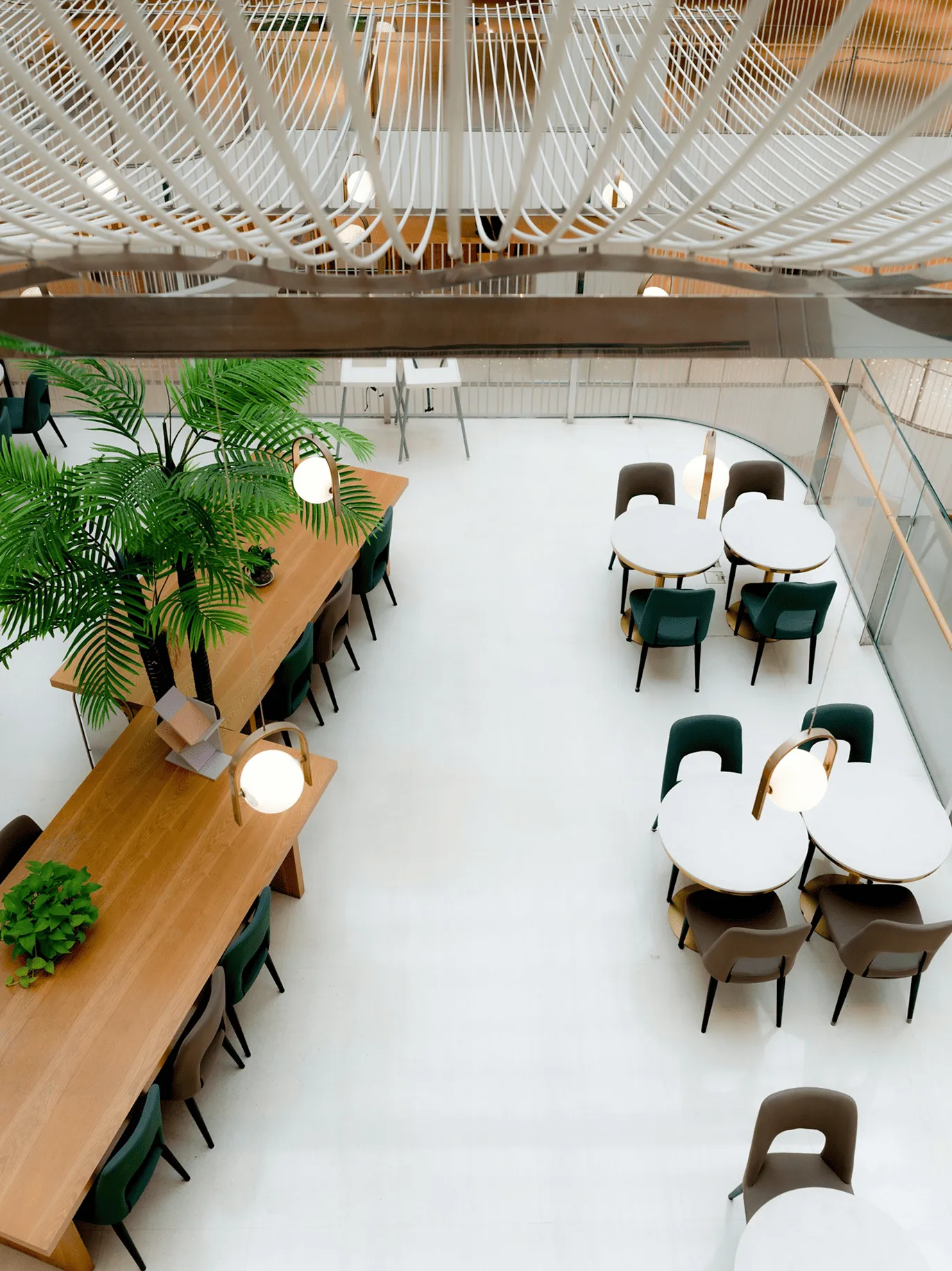 Reception desk with plants and clear divider in iHeart Media office lobby with company logo on wall.