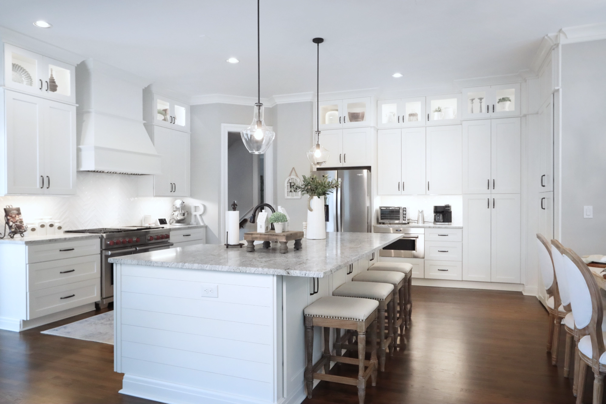 Kitchen remodel with new hardwood flooring and white cabinetry