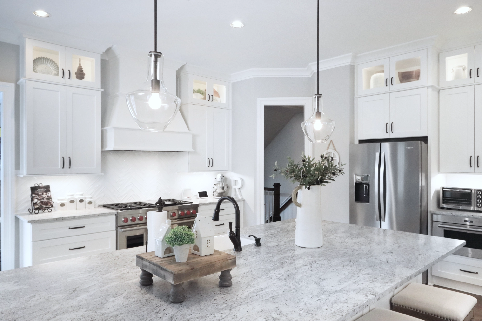 Kitchen remodel with white cabinetry with white quartz island