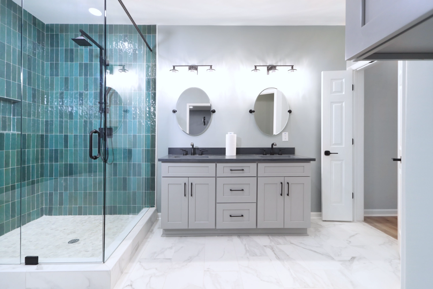 Basement bathroom with jack and jill sink, and frameless glass shower