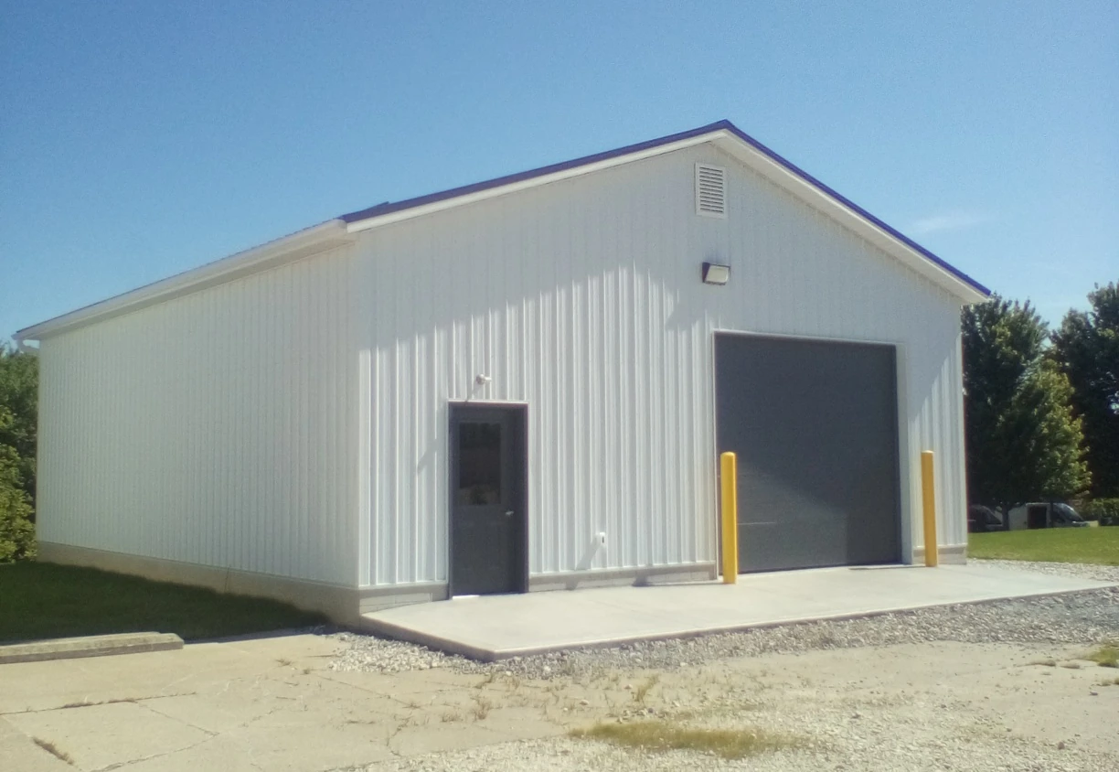 storage building with yellow safety poles in front
