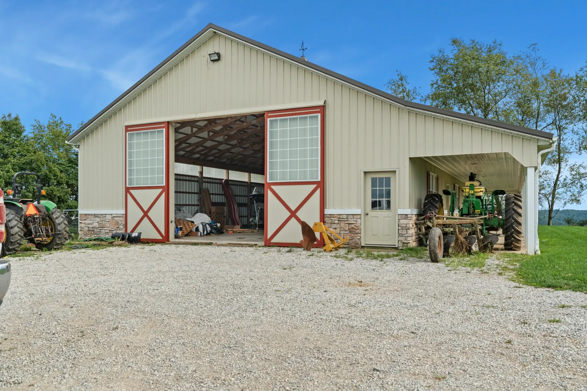 barn doors open with farm equipment