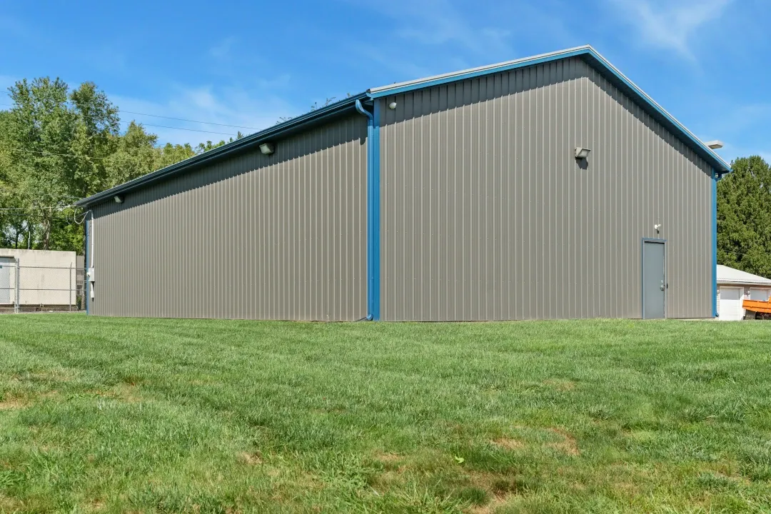 gray large storage building with blue trim