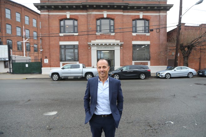 President of Mynt Properties, Joseph Smouha, poses for a photograph outside the company's Passaic office.  Mynt Properties is believed to be own more property in Passaic than any other individual or company. Tuesday December 10, 2019